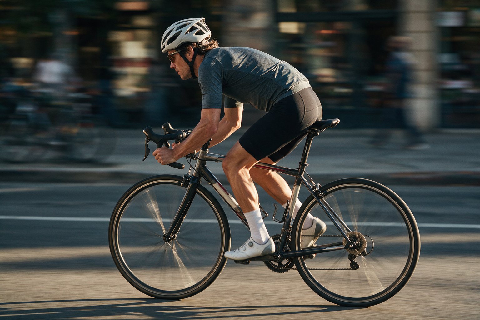 Panning shot of a cyclist with motion-blurred street behind